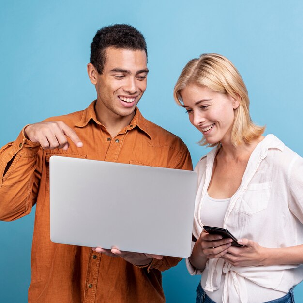 Young friends checking electronic devices