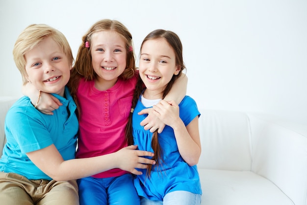 Young friends embraced on the sofa