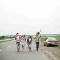 Free photo young friends enjoying together on countryside road