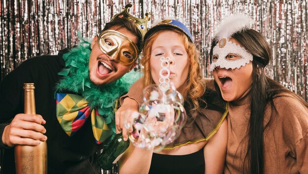 Молодые друзья веселятся на карнавальной вечеринке