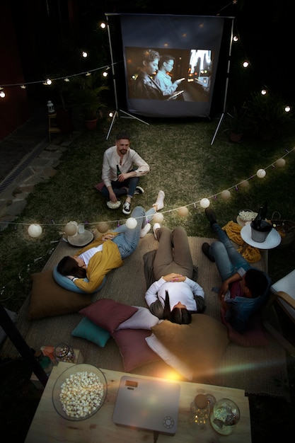 Free photo young friends having fun at cinema in open air