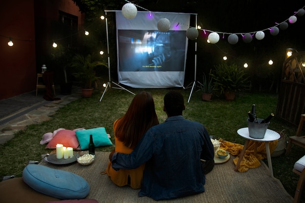 Young friends having fun at cinema in open air