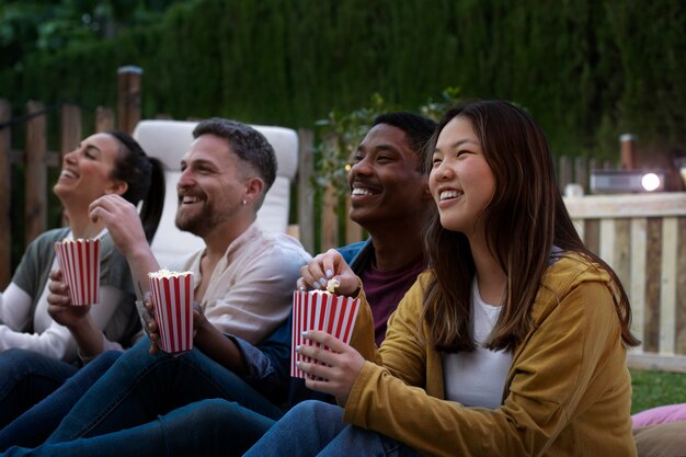 Young friends having fun at cinema in open air