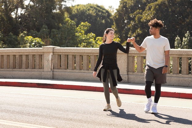 Free photo young friends at jogging doing fist bump