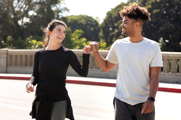 Young friends at jogging doing fist bump