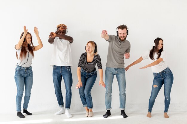 Young friends listening music and dancing