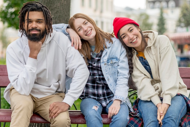 Young friends outdoor sitting on bench