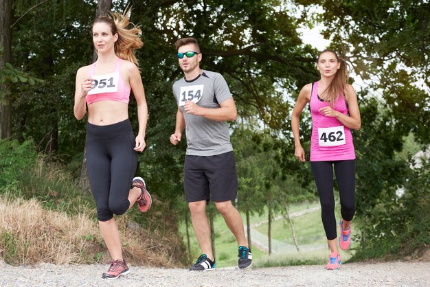 Young friends running during a marathon