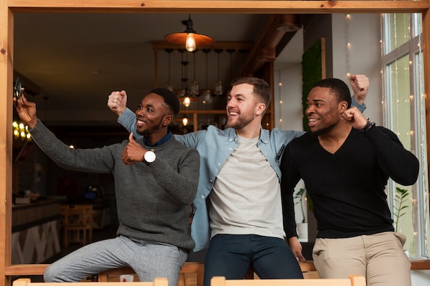 Free photo young friends showing ok sign in photos