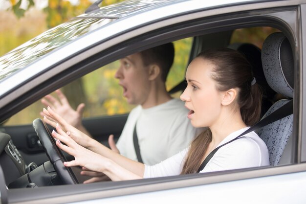 怖がった若い運転手の女性と男性
