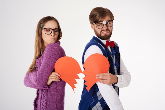 Young funny looking geek couple breaking up isolated