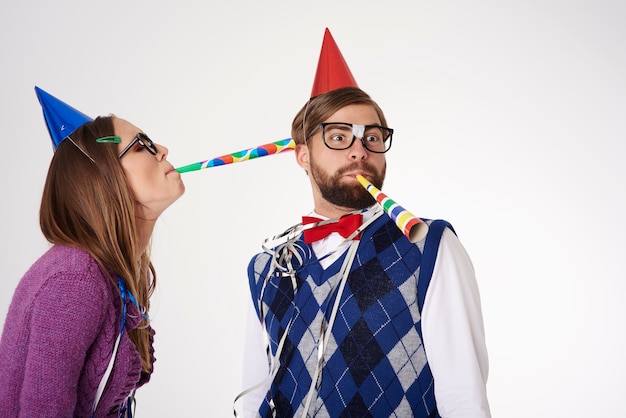 Young funny looking geek couple having fun isolated