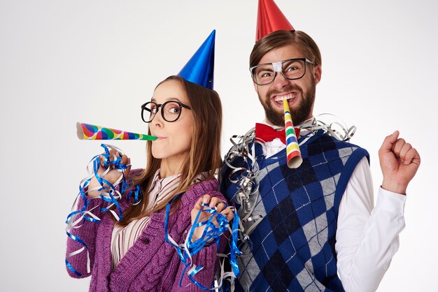 Young funny looking geek couple having fun isolated