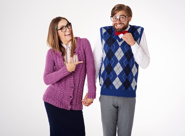 Young funny looking geek couple having fun isolated