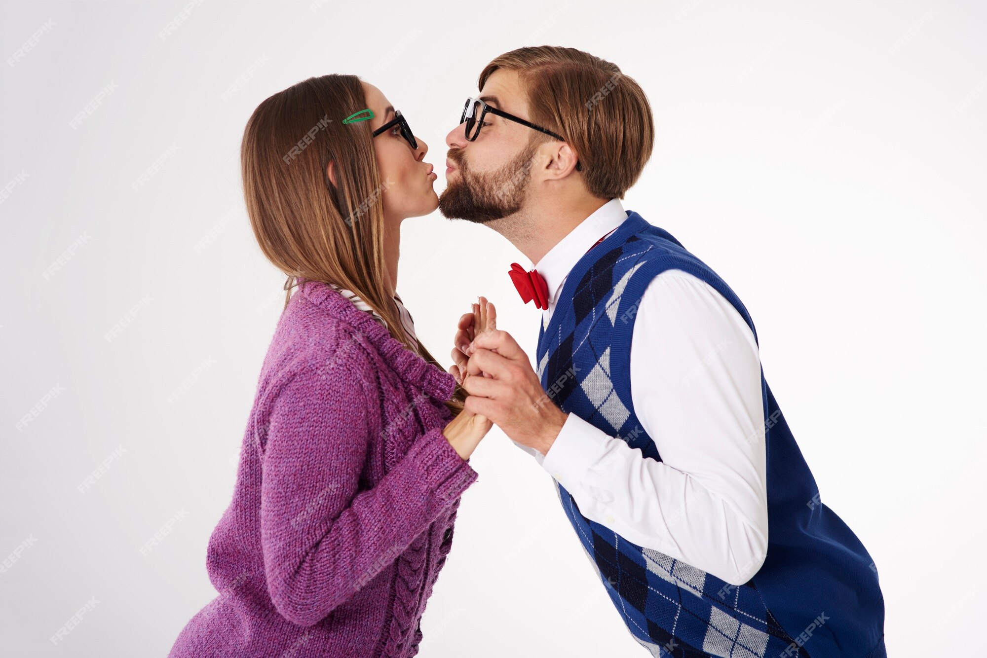Free Photo | Young funny looking geek couple kissing isolated