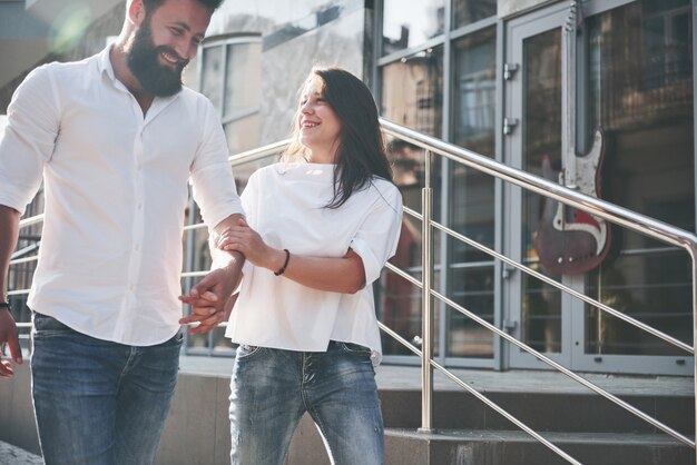 A young funny loving couple have fun on a sunny day.