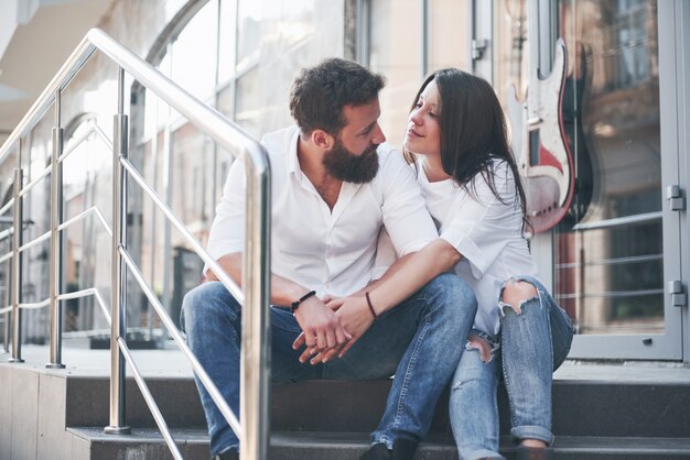 A young funny loving couple have fun on a sunny day.