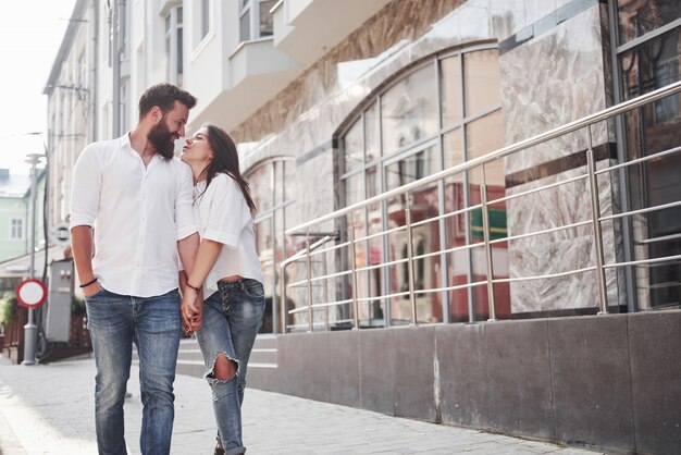 A young funny loving couple have fun on a sunny day.