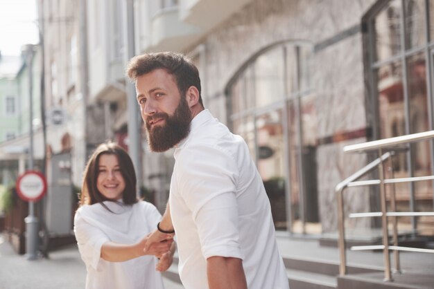 A young funny loving couple have fun on a sunny day.