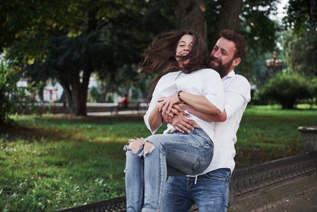 A young funny loving couple have fun on a sunny day.