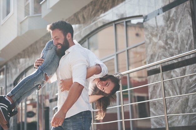 A young funny loving couple have fun on a sunny day.