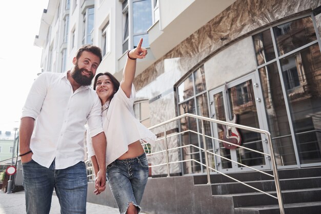 A young funny loving couple have fun on a sunny day.