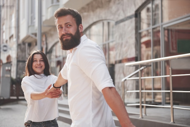 A young funny loving couple have fun on a sunny day.