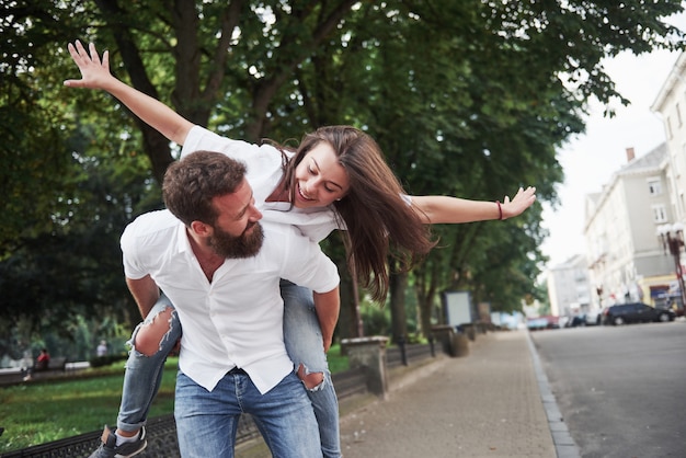 A young funny loving couple have fun on a sunny day.