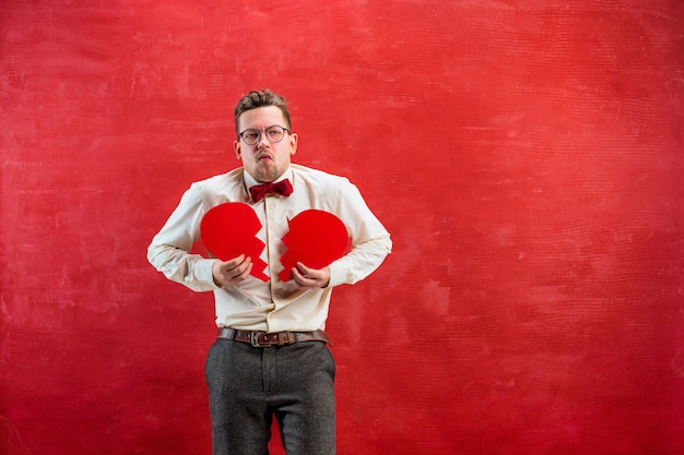 Free photo young funny man with abstract broken heart