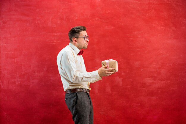 Young funny man with gift