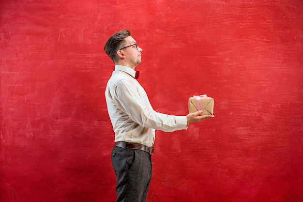 Young funny man with gift