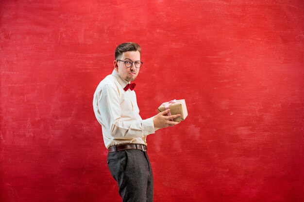 Young funny man with gift