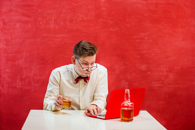 Young funny man with laptop at St. Valentine's Day