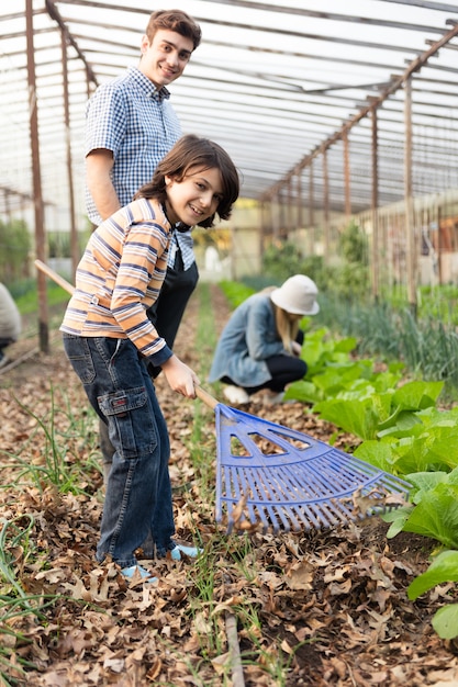 Young gardeners having fun in the greenhouse