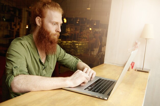 Young Ginger Man Using Laptop