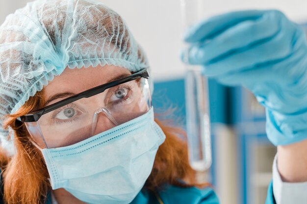 Young ginger woman chemist close-up