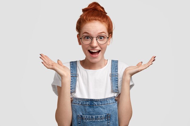 Young ginger woman wearing denim overalls