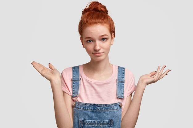 Free photo young ginger woman wearing denim overalls