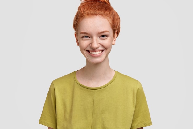 Young ginger woman wearing green T-shirt