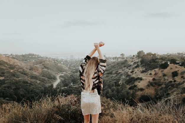 Young girl in a beautiful outfit on top of the mountain