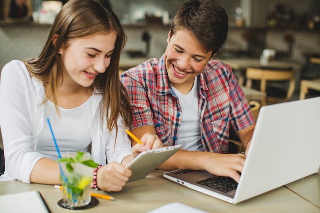 Young girl and boy with gadgets