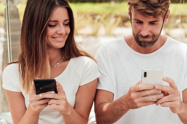 Young girl checking her friends smartphone