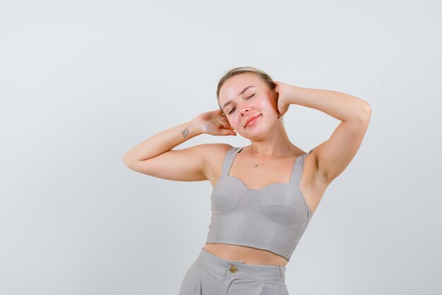 Young girl closing her eyes on white background