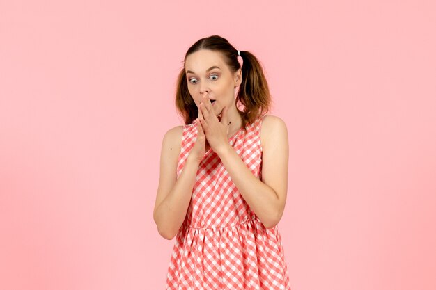 young girl in cute pink dress with shocked expression on pink