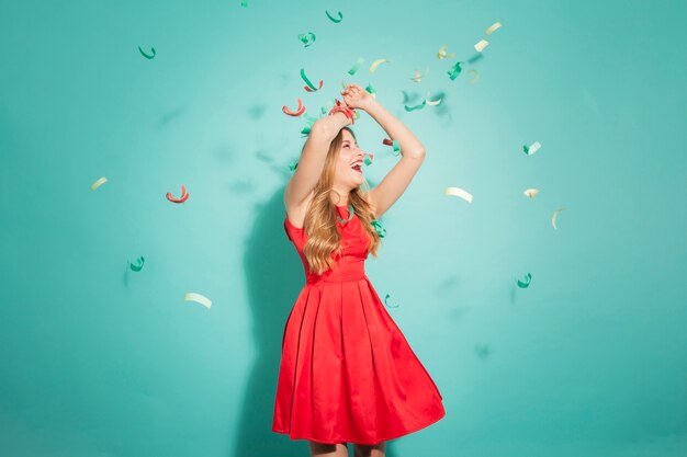 Young girl dancing under confetti