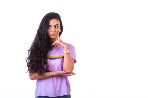 Young girl doing attentive listening hand sign.