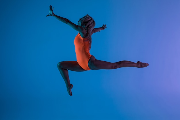 Young girl doing gymnastics exercise isolated