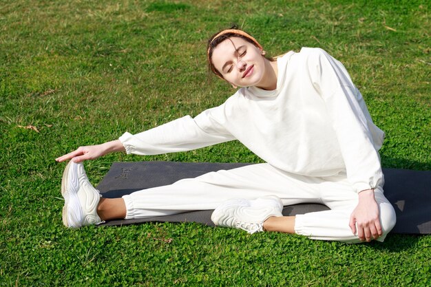 Young girl doing her daily exercises at the park High quality photo