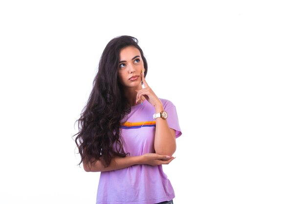 Young girl doing thinking hand sign. 