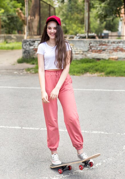 Young girl doing tricks with her skateboard outdoors